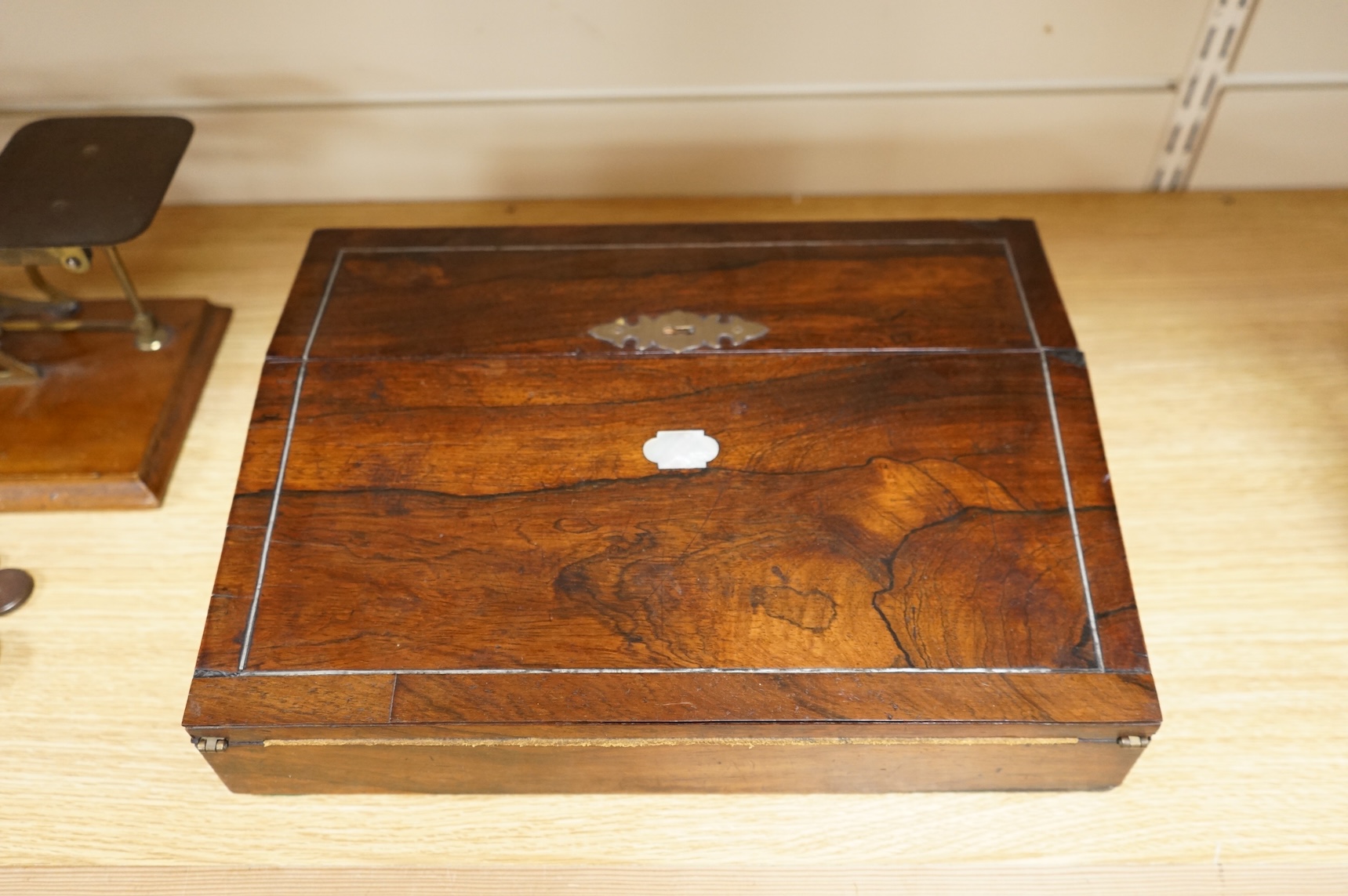 A tooled leather writing slope, a letter rack and postage scales, largest 37cm wide